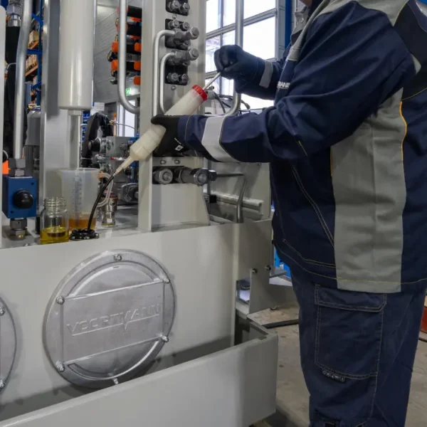 Hidraulika technikus olajmintát vesz a tápegységből laborvizsgálat céljából